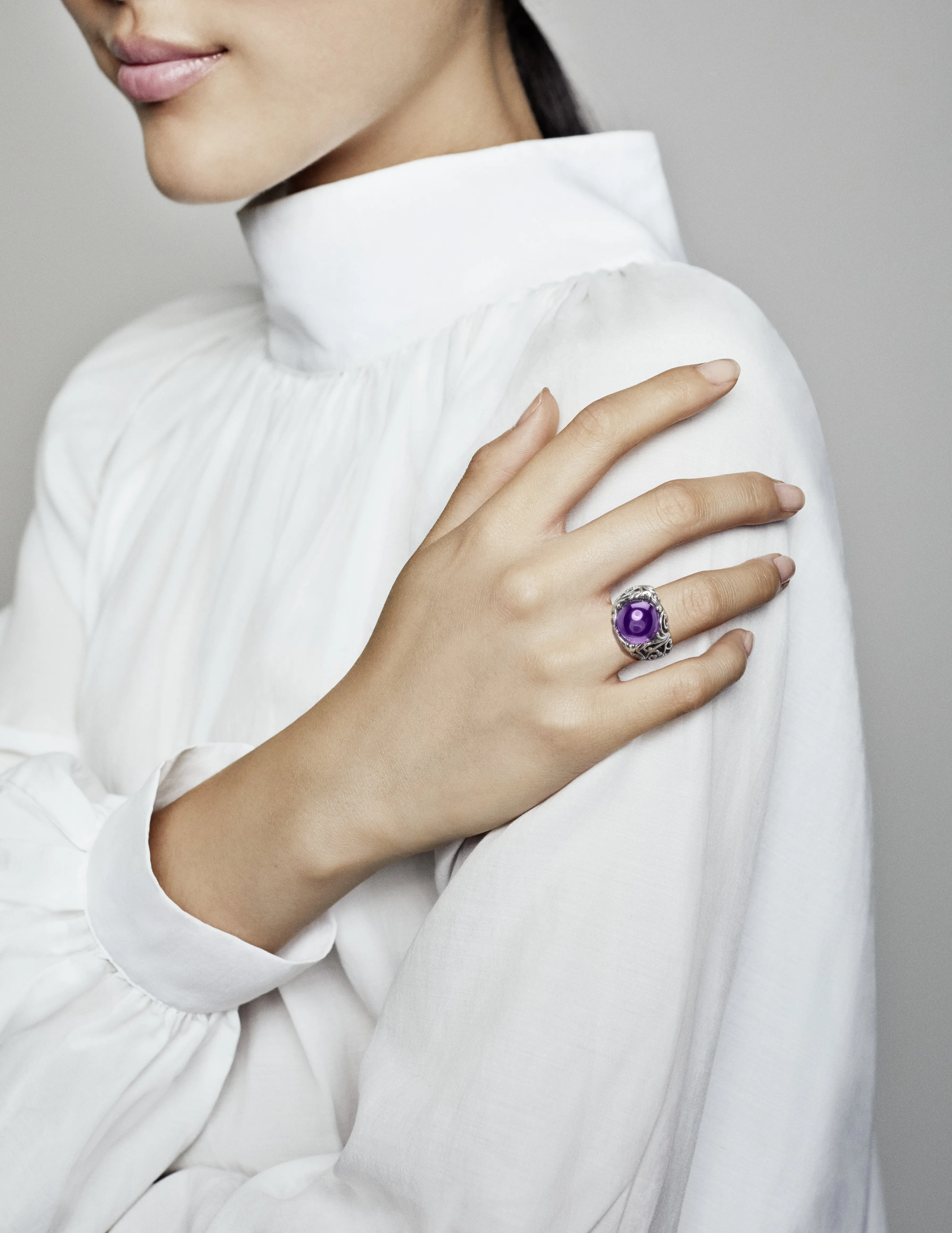 Regal pattern silver ring with purple cubic zirconia