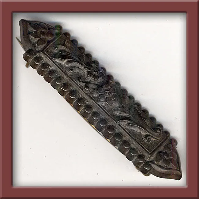 Victorian pressed horn brooch with floral design. j-pnvc984